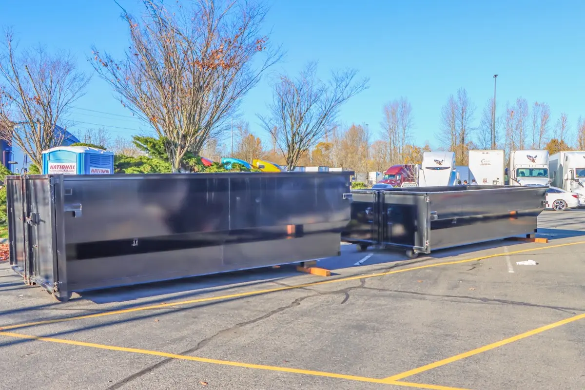 Professional dumpster rental service with roll-off container on residential driveway in Rutherford